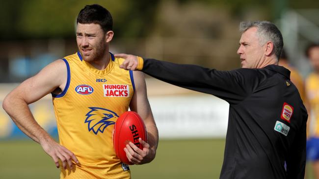 West Coast coach Adam Simpson directs star defender Jeremy McGovern, left, at training. Picture: Richard Wainwright/AAP