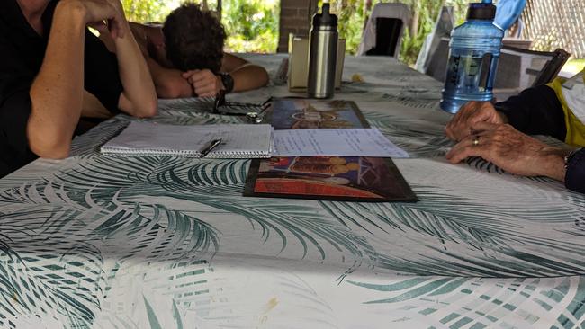 A 14-year-old Palmerston College student slumps as his mum speaks on the phone to Palmerston MLA Marie-Clare Boothby. Their investigation notes are on the table. Picture: Alex Treacy