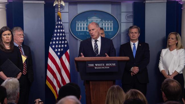 Director of National Intelligence Dan Coats (C) speaks at the White House press briefing beside (from left) Press Secretary Sarah Huckabee Sanders; National Security Advisor John Bolton; Gen. Paul Nakasone (partially obscured), Commander of the US Cyber Command; FBI Director Christopher Wray; and Homeland Security Secretary Kirstjen Nielsen (R). Picture: AFP.