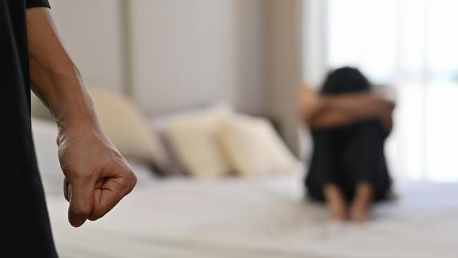 istock generic:  woman, abuse, DV, domestic violence, harassment, sexual harassment.   Selective focus on the fist male with crying man sits on a bed as the background, Violence, Love and relationships, Gay couple, sexual harassment concept. . Picture: istock