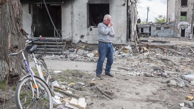 A man breaks down after placing flowers among the rubble of Borodyanka, outside the capital, Kyiv. Picture: Gary Ramage