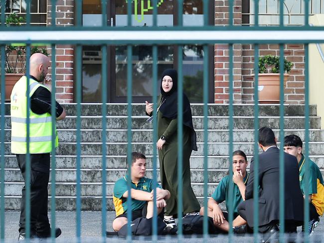 Police and staff outside of Granville Boys’ High School during a protest in support of Sheikh Wesam Charkawi. Picture: John Feder/The Australian