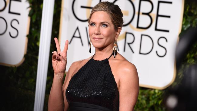 Playing it down ... Aniston arriving on the red carpet at the Golden Globe Awards in a sleek but low key Saint Laurent gown.