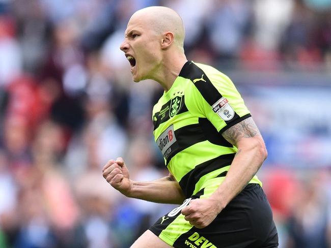 Huddersfield Town's Australian midfielder Aaron Mooy celebrates after scoring his penalty in the shoot-out during the English Championship play-off final football match between Huddersfield Town and Reading at Wembley Stadium in London on May 29, 2017. Huddersfield won the penalty shoot-out 4-3 after the game finished 0-0 after extra time.  / AFP PHOTO / Glyn KIRK / NOT FOR MARKETING OR ADVERTISING USE / RESTRICTED TO EDITORIAL USE