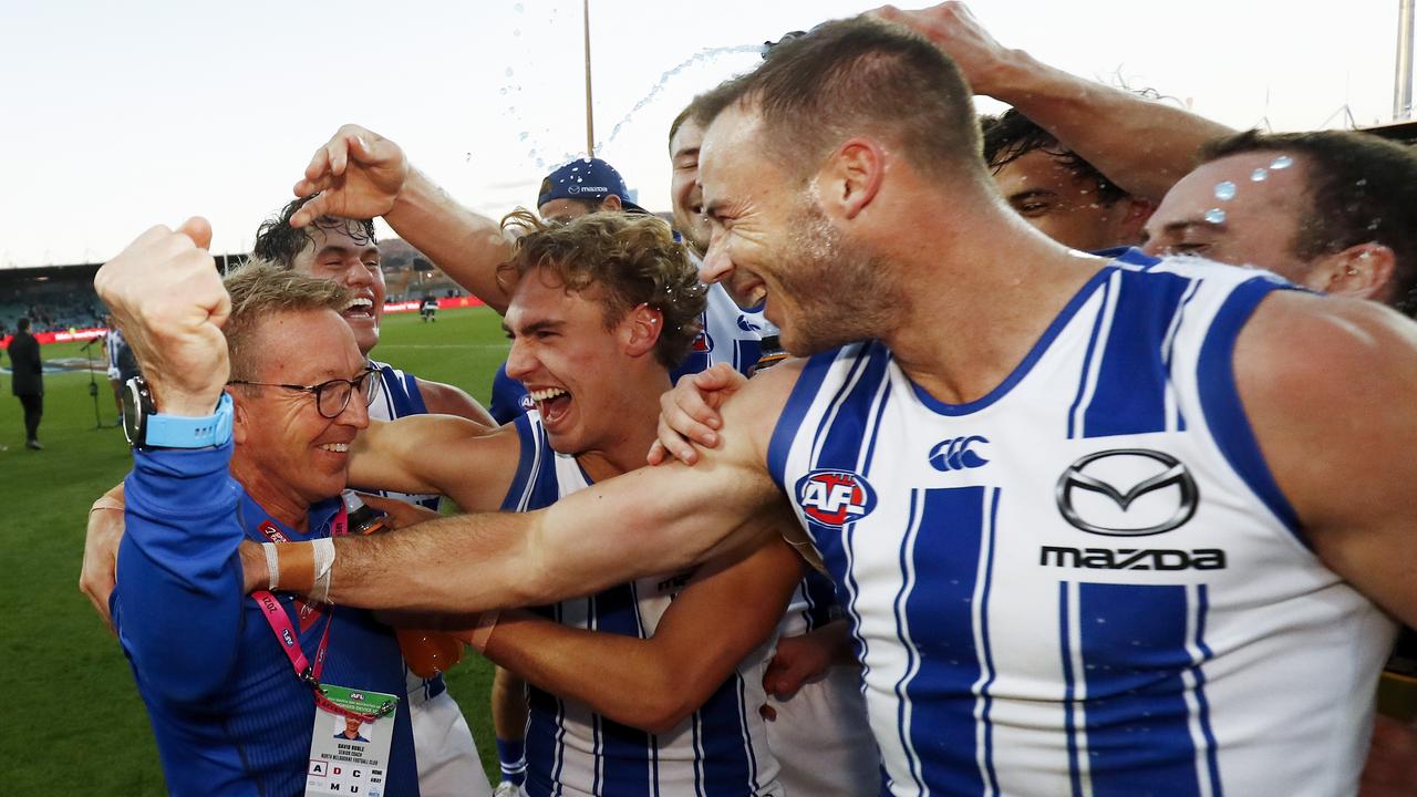 LAUNCESTON, AUSTRALIA - MAY 15: Senior coach David Noble of the Kangaroos celebrates a win with his players during the 2021 AFL Round 09 match between the Hawthorn Hawks and the North Melbourne Kangaroos at UTAS Stadium on May 15, 2021 in Launceston, Australia. (Photo by Dylan Burns/AFL Photos via Getty Images)