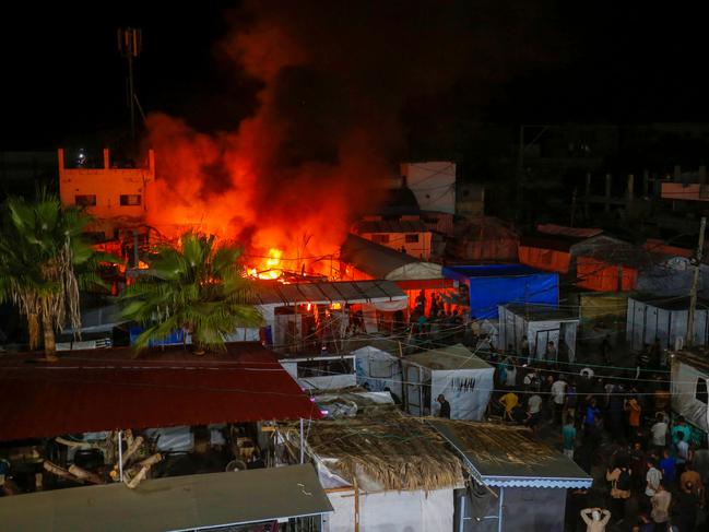 People at the site of an Israeli air strike around tents for displaced people inside the walls of Al-Aqsa Martyrs Hospital in Deir al-Balah, in the central Gaza Strip. Picture: AFP