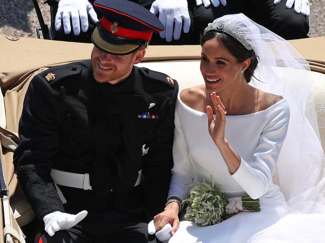 Britain's Prince Harry, Duke of Sussex and his wife Meghan, Duchess of Sussex ride in the Ascot Landau Carriage as they pass through the Cambridge Gate into the grounds of Windsor Castle at the end of their carriage procession in Windsor, on May 19, 2018 after their wedding ceremony. Picture: AFP PHOTO / Yui Mok