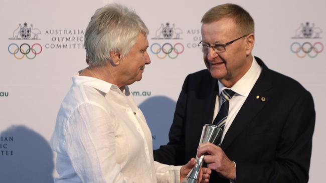 Australian Olympian Raelene Boyle, left, is given the Order of Merit award from the Australian Olympic Committee (AOC) President, John Coates, during the AOC annual general meeting yesterday (AP Photo/Rick Rycroft)