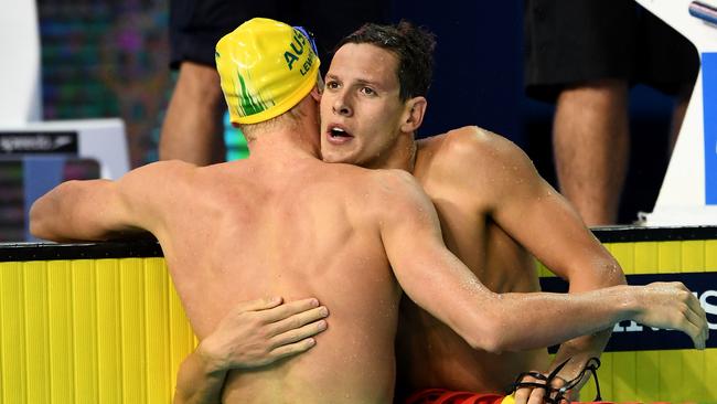 Mitch Larkin hugs Clyde Lewis after they finished 1-2 in the 200m individual medley. Picture: Quinn Rooney/Getty Images