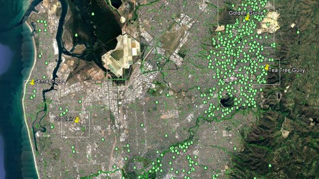 A an aerial view of Adelaide via Google Earth with small green tree icons denoting the location of parks and reserves.