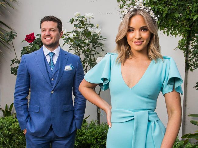 Olivia Molly Rogers her fiancÅ½ Justin McKeone at home in Glen Iris wearing their Melbourne Cup outfits. Olivia is a Fashions on your Front Lawn ambassador, and will be judging the competition from home.Photograph by Paul JeffersThe Australian30 Oct 2020