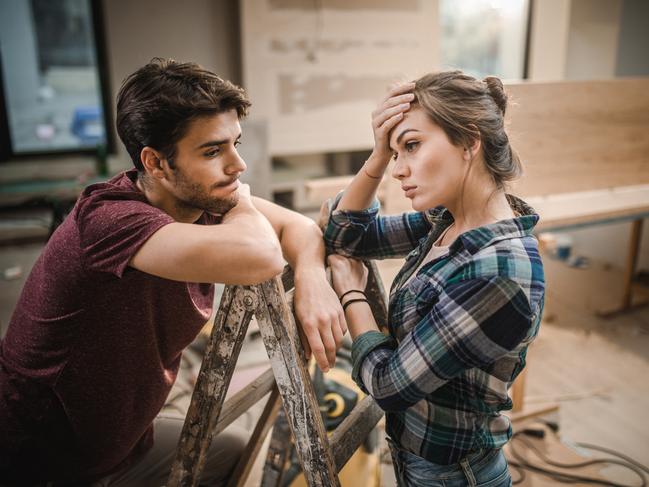 Worried couple standing on ladders and thinking the easiest way possible for home renovation.