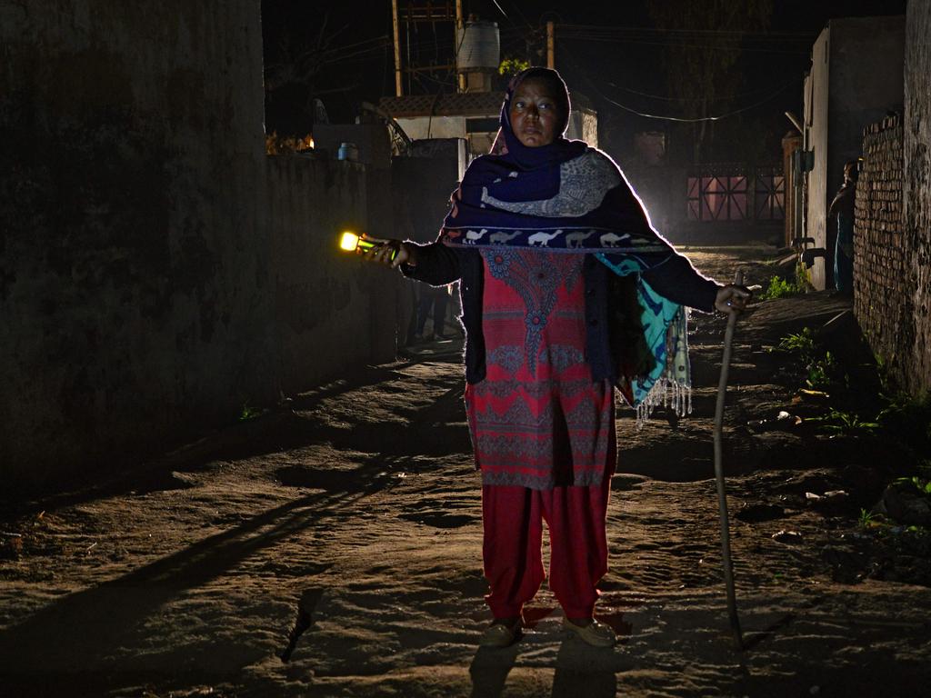 Kuldeep KaurIndian, 51, an Indian watchwoman, walks with a flashlight during her night round at Bhangiwal village near Mehatpur, some 40km south from Jalandhar on February 24, 2018. Picture: AFP
