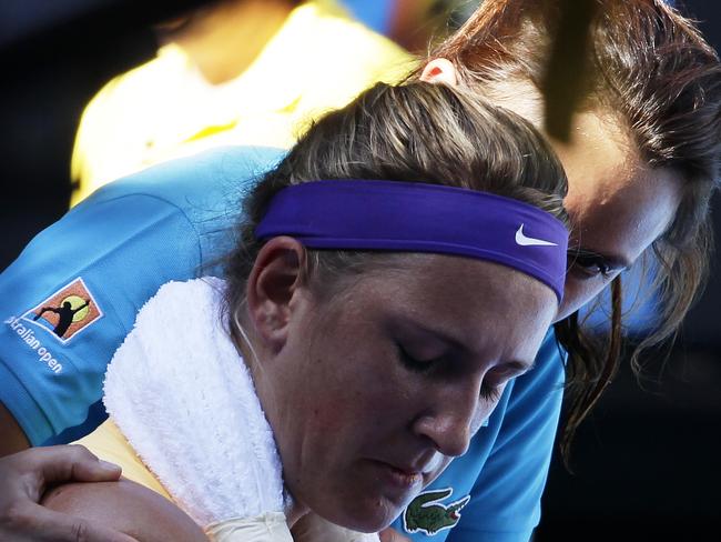 Victoria Azarenka of Belarus receives medical attention  during her match against Sloane Stephens of the USA in the women's singles semifinals of the Australian Open tennis tournament in Melbourne on Thursday, Jan. 24, 2013. (AAP Image/Narendra Shrestha) NO ARCHIVING, EDITORIAL USE ONLY