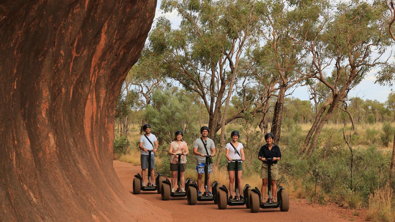 Visitors can travel around the base of Uluru by segway. Picture: Voyages Indigenous Tourism Australia