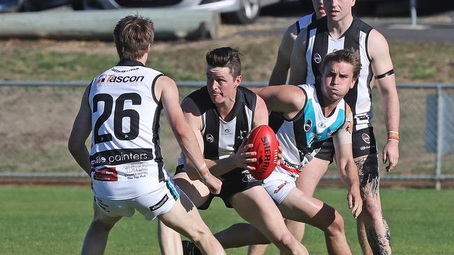 SFL: Claremont vs. Cygnet, Abbotsfield Park: Claremont's Luke Potter (centre) looks to get past the tackle of Cygnet's Toby Cowen. Picture: LUKE BOWDEN