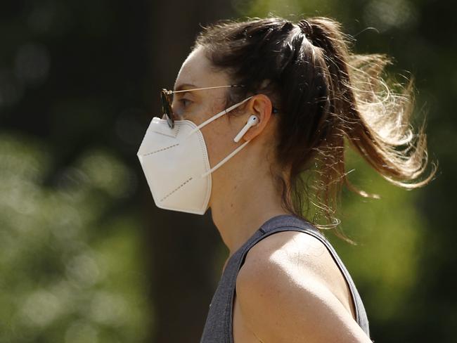 MELBOURNE, AUSTRALIA - NCA NewsWire Photos November 21, 2020:  A woman is seen wearing a mask whilst exercising along the Tan walking track in Melbourne, Victoria. Picture: NCA NewsWire / Daniel Pockett