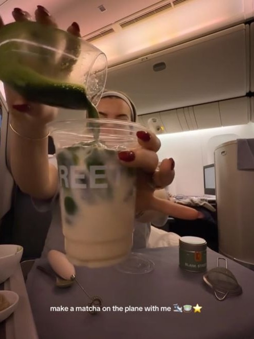 The woman had no qualms about what her fellow passengers thought of her DIY drink set up. Picture: TikTok