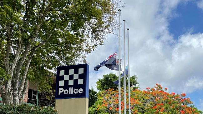 The flags at the Bundaberg police station fly at half mast for the slain officers.