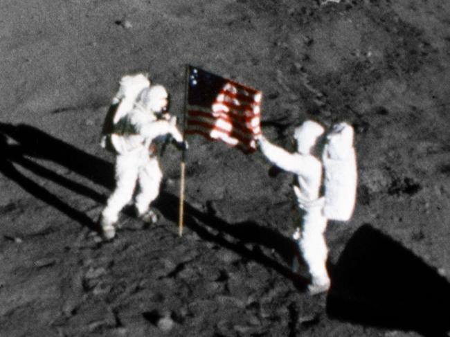 Astronaut Neil A. Armstrong, stands on the left at the flag's staff. Astronaut Edwin E. Aldrin Jr., also pictured. Pic taken by the 16mm Data Acquisition Camera (DAC) mounted in the LM - deploy flag. (Photo by: HUM Images/Universal Images Group via Getty Images)