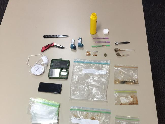 Drugs and items uncovered during a police search in Airlie Beach on Thursday. Police allege more than 1kg of MDMA was uncovered.