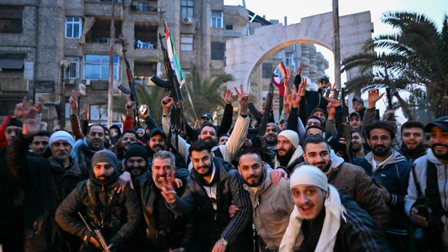 Local residents cheer as the gather on a street in the Damascus suburb of Jaramana. Picture: Louai Beshara/AFP