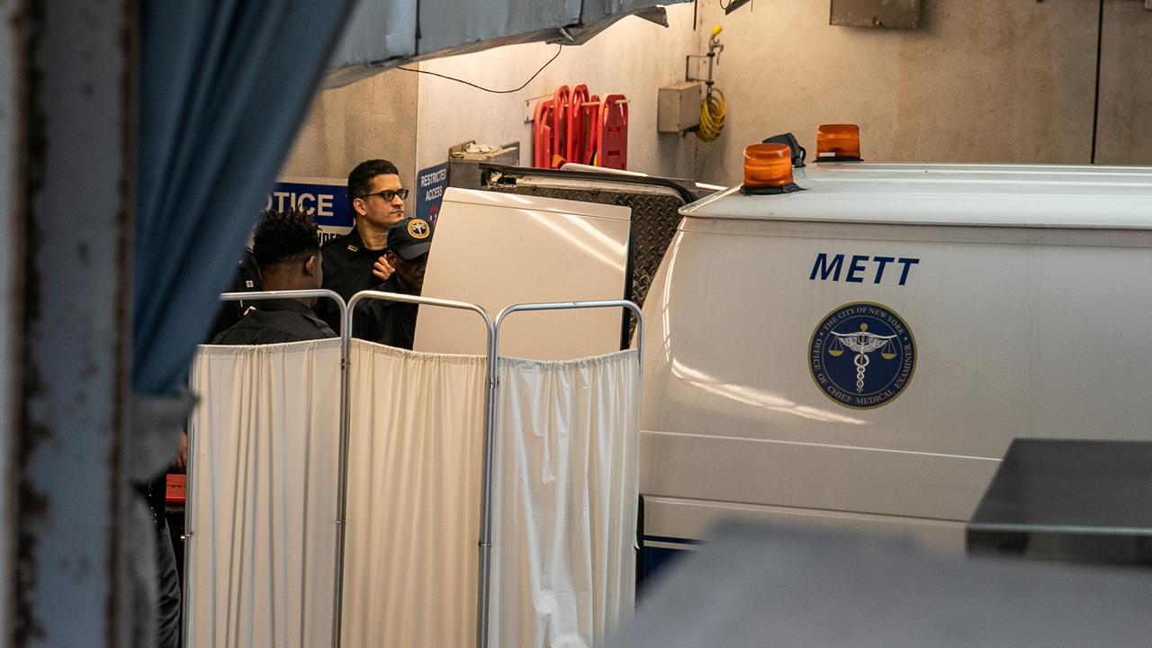 Police officers cover a medical examiner car outside New York Presbyterian-Lower Manhattan Hospital, where Jeffrey Epstein's body was transported before being moved to a medical examiner's office in Manhattan borough of New York City, New York. Picture: Reuters/Jeenah Moon