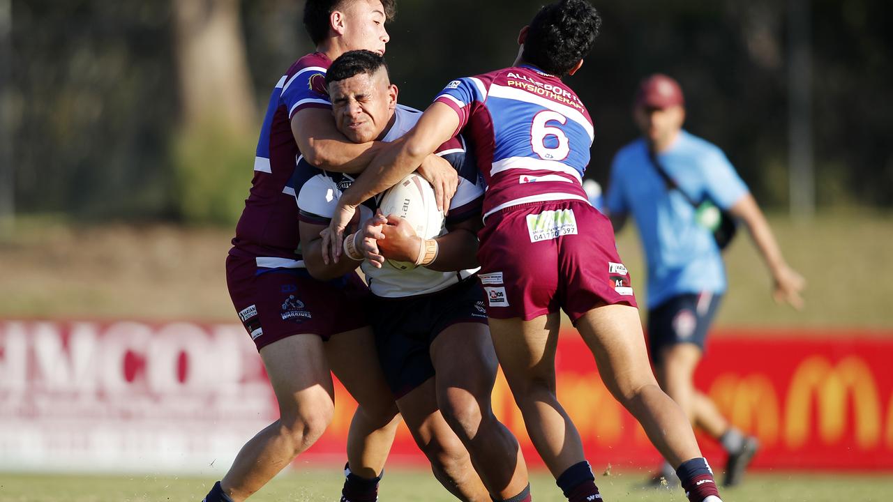 Josiah Pahulu of Ipswich takes a tough hit up against Wavell State High. Picture: Josh Woning