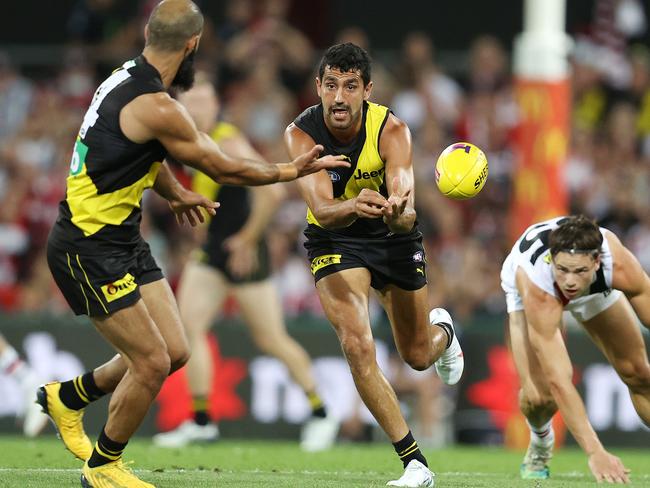 Marlion Pickett clears by hand to Bachar Houli. Picture: Michael Klein