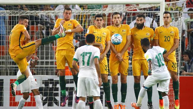 Trent Sainsbury, far right, in a an Australian wall featuring Matthew Spiranovic.