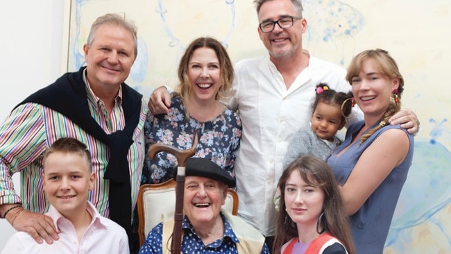 John Olsen with his signature beret (middle) surrounded by family. Picture: Supplied