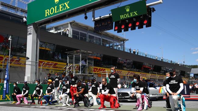 Drivers kneel behind a banner reading ‘End Racism’ ahead the Austrian Formula One Grand Prix in 2020. Picture: AFP