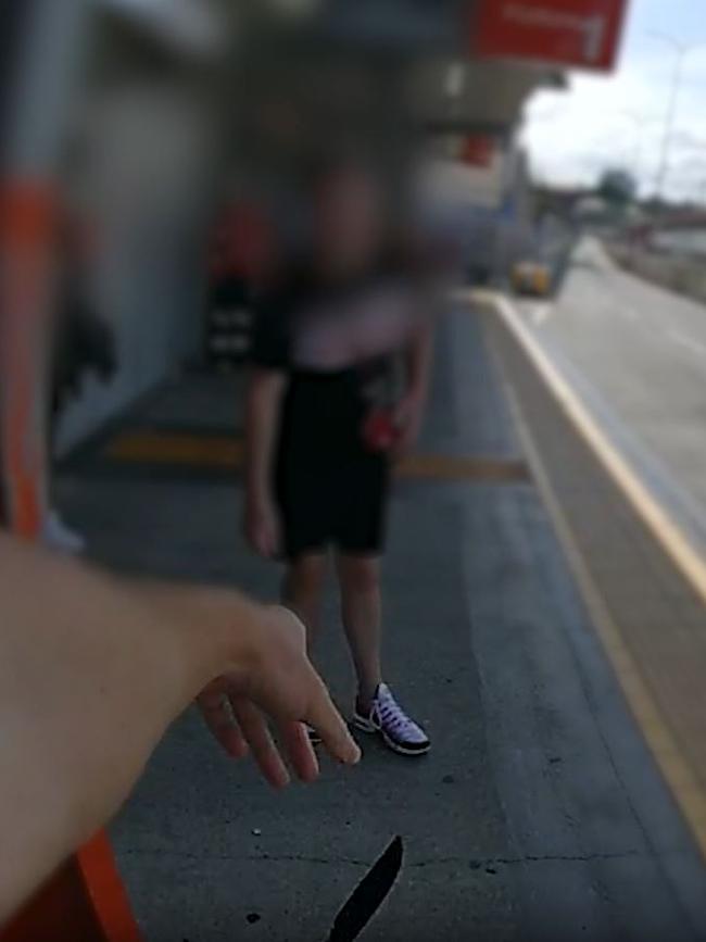 Police bodycam captured the moment a young man produced a 30cm hunting knife at a busy bus stop in Brisbane on Tuesday afternoon. Picture: Supplied / Queensland Police