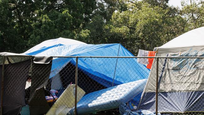 Tents in a fenced off area at Musgrave Park in South Brisbane. Rising rents are worsening the homelessness crisis.