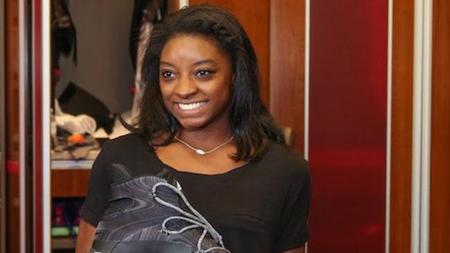 Simone Biles is dwarfed by Robin Lopez’s shoe.