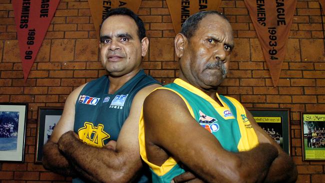 Premiership Flags and Team Pictures adorn the St Mary's Clubrooms walls as club legends Michael Long and Leon Gregory stand proudly in front