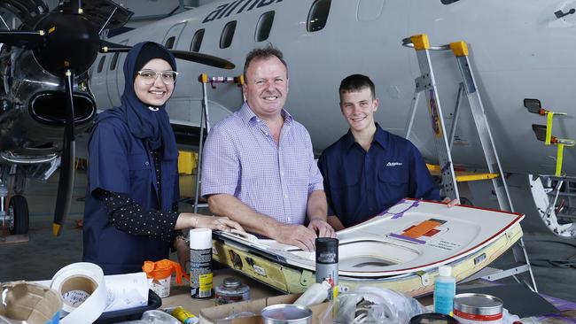 Aviation Australia has partnered with Jet Aviation to provide over 20 cadetships for Licenced Aircraft Maintenance Engineers, addressing the skills shortage suffered during the covid pandemic. Khalisah Mohammed, 22, and Marcus Stallan Caamano, 16, inspect some bodywork from an Air North turbo prop aircraft with Aviation Australia business manager Chris Pigott. Picture: Brendan Radke