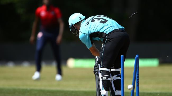 David Warner has his middle stump knocked over by Lasith Malinga.