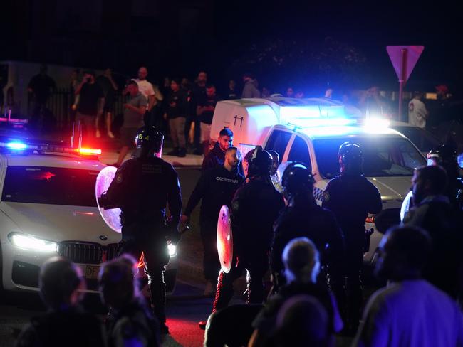 Photos on the night of the Wakeley riots where hundreds of people descended on the Good Shepherd Church on Box Road in Wakeley.