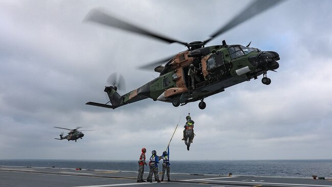 An MRH-90 helicopter practising winching operations with Aviation Support trainees on the HMAS Adelaide. Picture: Royal Australian Navy