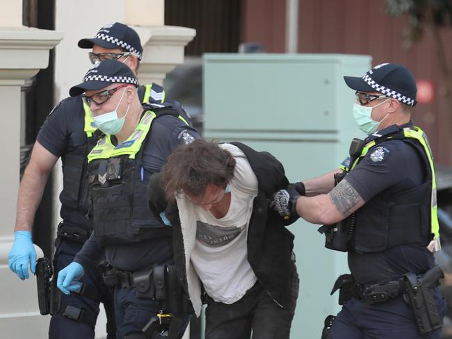 Police arrest a man near the CFMEU office on Thursday. Picture: David Crosling