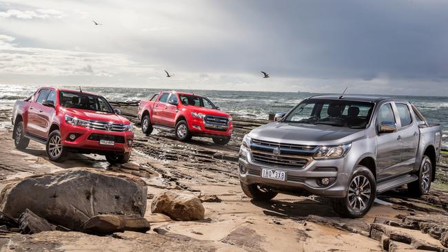 The Toyota HiLux (left), Ford Ranger (centre) and Holden Colorado (right) are being discounted in the lead-up to the end of the year. Picture: Thomas Wielecki