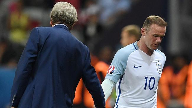 England's forward Wayne Rooney shakes hands with England's coach Roy Hodgson.