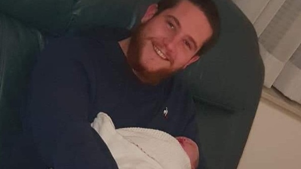 Jordan with his newborn daughter.