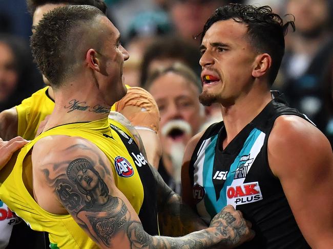 ADELAIDE, AUSTRALIA - JULY 01: Travis Boak, Sam Powell-Pepper of the Power and Dustin Martin of the Tigers wrestle during the round 15 AFL match between the Port Adelaide Power and the Richmond Tigers at Adelaide Oval on July 1, 2017 in Adelaide, Australia.  (Photo by Daniel Kalisz/Getty Images)