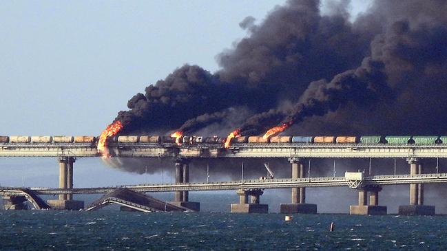 Smoke billows from the Kerch bridge linking Crimea to Russia, after a truck exploded on Saturday. President Vladimir Putin personally opened it in 2018. Picture: AFP