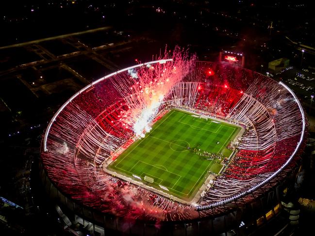 In Argentina fans celebrate before the “beautiful game” starts. Fireworks fill the air prior to a match between River Plate and Estudiantes. Picture: Tomas Cuesta/Getty Images