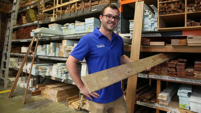 Botany Timber’s Alastair Kelly with a plank of spotted gum, popular for decking, which will be in short supply due to fires destroying forests Picture: Britta Campion