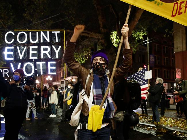 Demonstrators hold signs during a march to "Count Every Vote, Protect Every Person" in Seattle, Washington. Picture: Jason Redmond/AFP