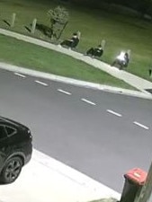 A suspicious trio clad in black sitting across the street from Natalie's home, watching it and taking photographs.